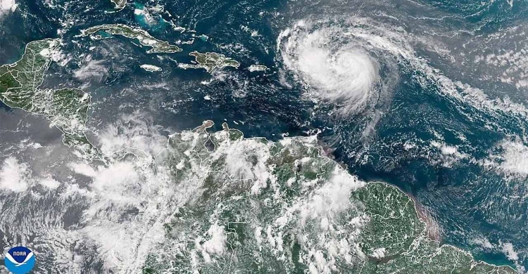 Hurricane Erin intensifies offshore, lashes Caribbean with rain