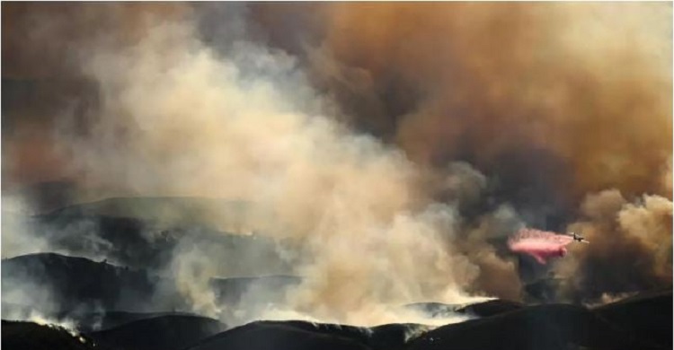 Air tankers fight Los Angeles fires from frantic skies